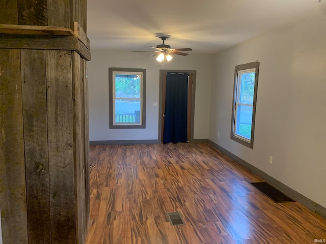 unfurnished room featuring dark hardwood / wood-style floors and ceiling fan