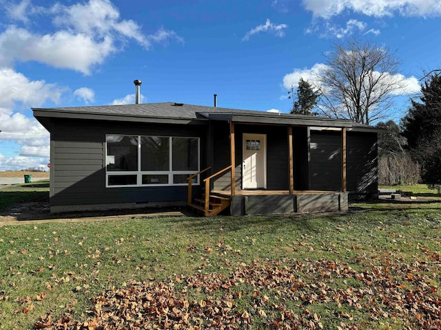 back of house featuring a sunroom and a yard