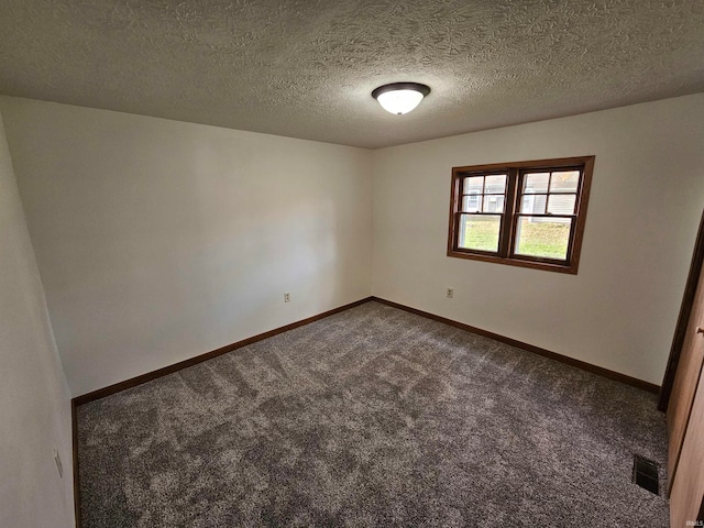 carpeted empty room with a textured ceiling