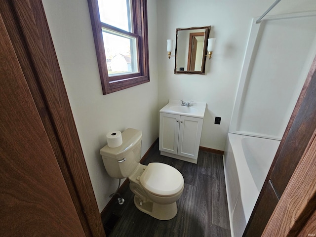 bathroom with vanity, hardwood / wood-style flooring, and toilet