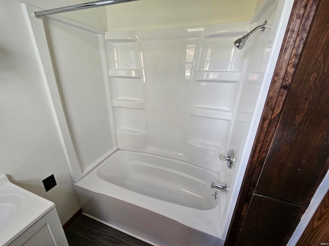 bathroom with shower / washtub combination, vanity, and wood-type flooring