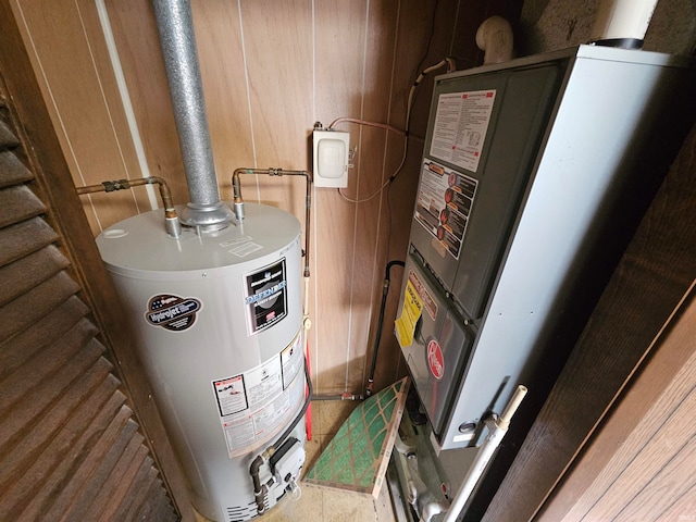 utility room with gas water heater and heating unit