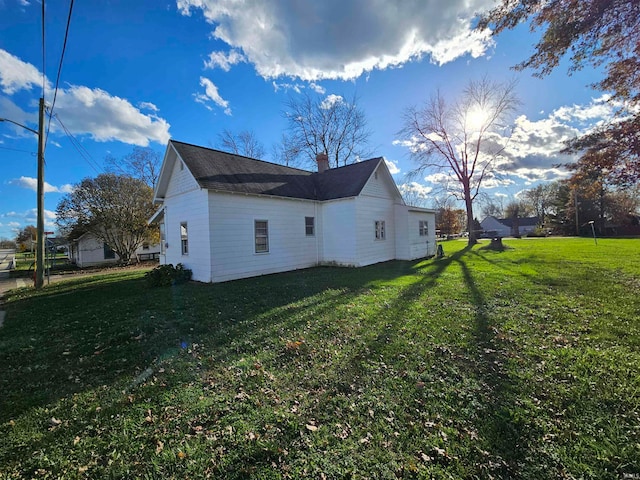 view of side of home with a lawn