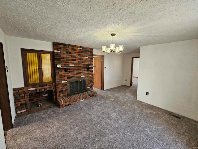 unfurnished living room with a fireplace, carpet floors, a textured ceiling, and a chandelier