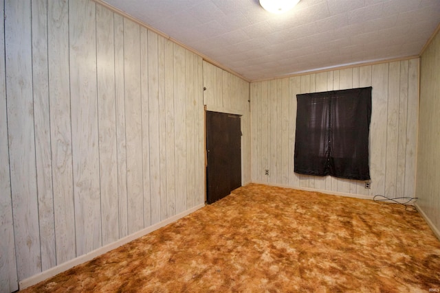 empty room with wooden walls and carpet floors