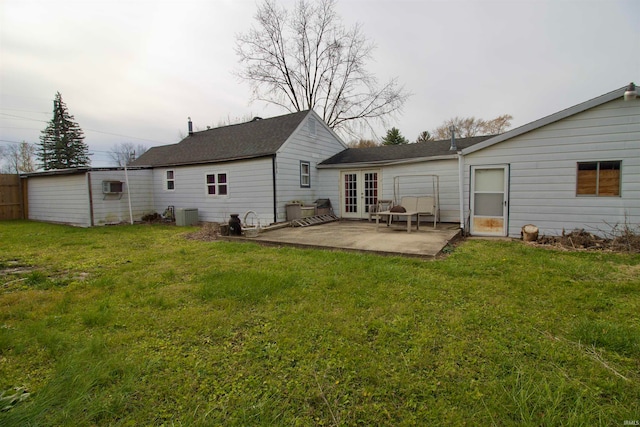 back of house with a lawn, cooling unit, a patio area, and an AC wall unit