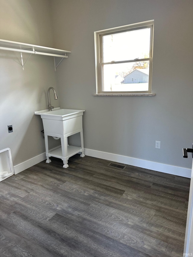 clothes washing area with hookup for an electric dryer and dark hardwood / wood-style floors