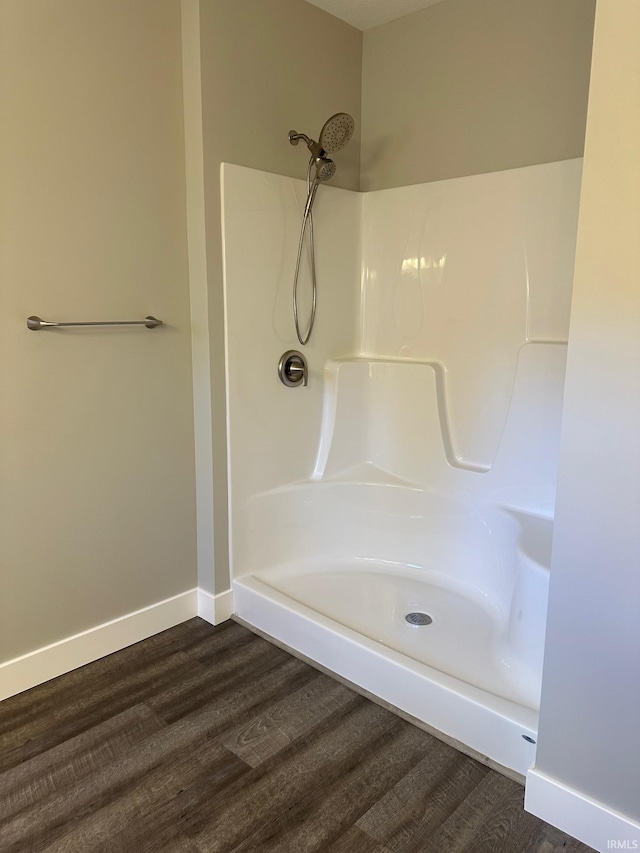 bathroom featuring a shower and hardwood / wood-style flooring