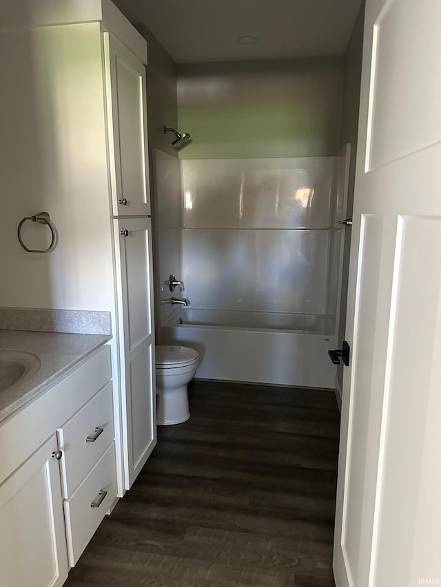 full bathroom featuring shower / washtub combination, vanity, wood-type flooring, and toilet