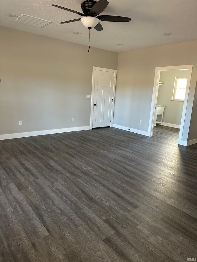 unfurnished room with ceiling fan and dark hardwood / wood-style floors