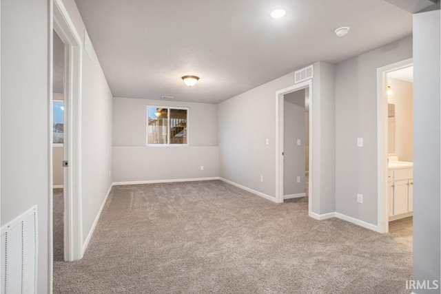 spare room featuring light colored carpet