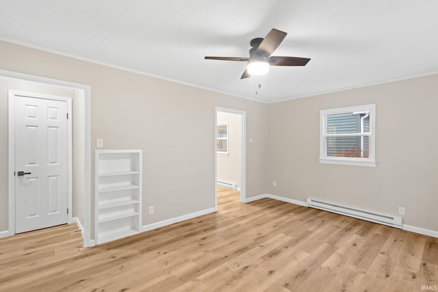 spare room with ceiling fan, crown molding, light hardwood / wood-style flooring, and a baseboard radiator