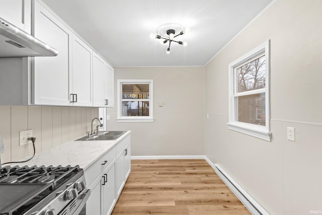 kitchen featuring white cabinetry, sink, stainless steel gas stove, exhaust hood, and light wood-type flooring