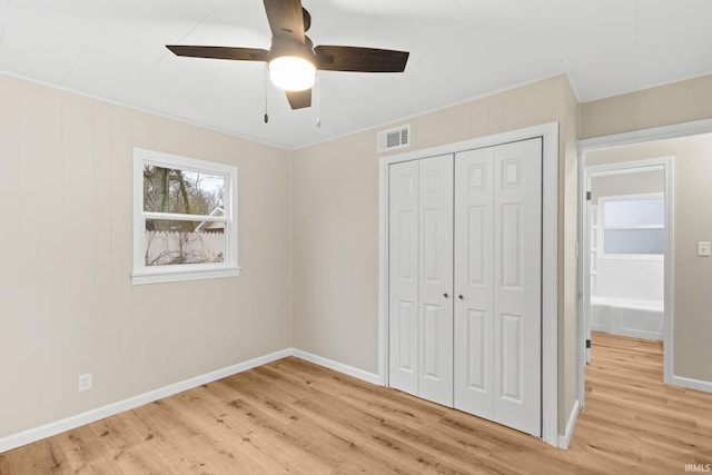 unfurnished bedroom with a closet, light hardwood / wood-style flooring, ceiling fan, and ornamental molding