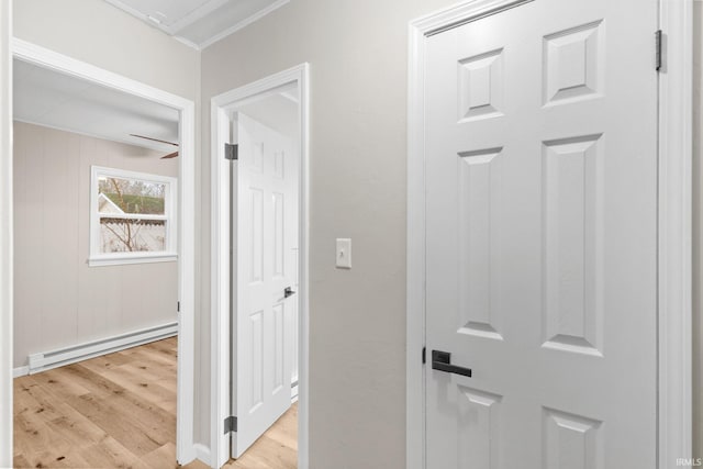 hallway featuring light hardwood / wood-style flooring and a baseboard heating unit