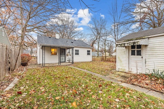 back of property featuring a lawn and a patio