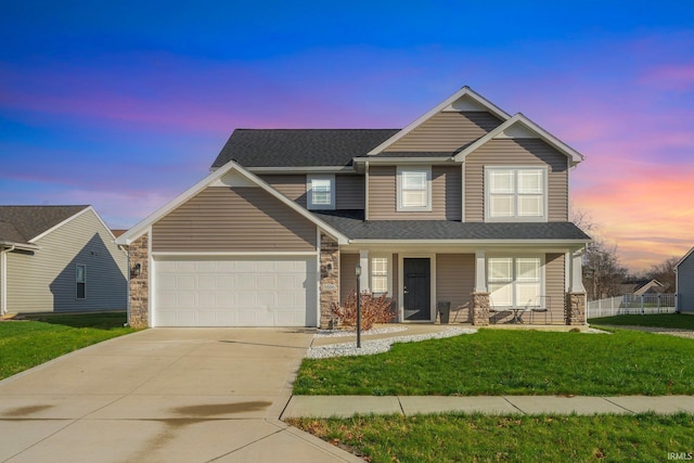 craftsman-style home featuring a lawn, a porch, and a garage