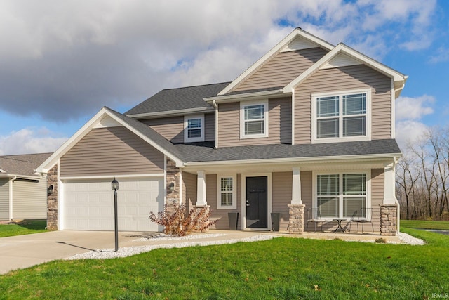 craftsman-style house featuring covered porch, a garage, and a front yard