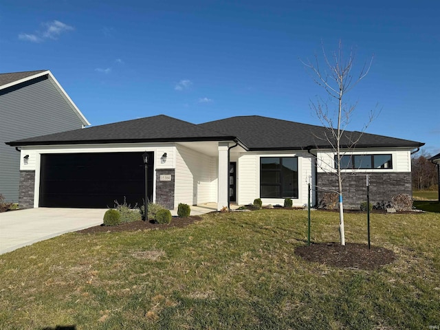 view of front of house featuring a garage and a front lawn