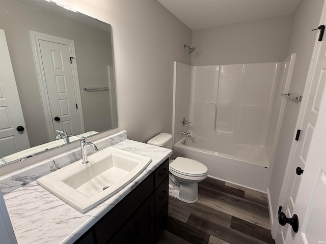 full bathroom featuring toilet, vanity, bathtub / shower combination, and hardwood / wood-style flooring