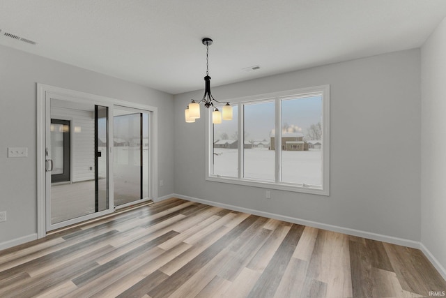 15384 Brimwillow Dr, Huntertown, IN 46748 - empty room with a chandelier, wood finished floors, and baseboards