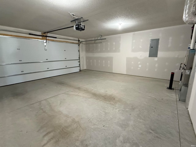 garage with a garage door opener and electric panel