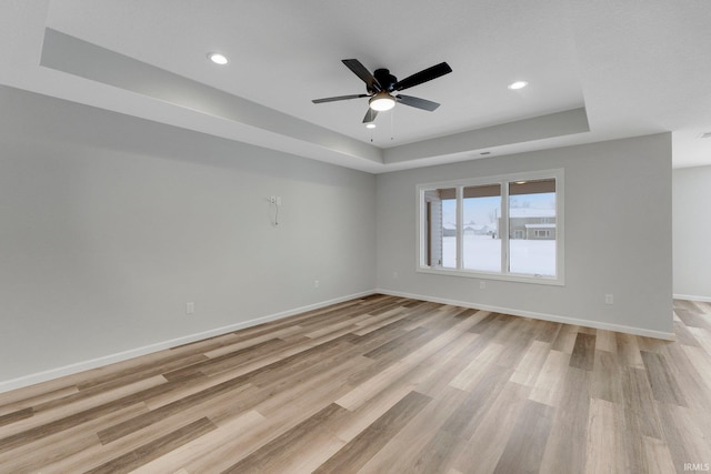 15384 Brimwillow Dr, Huntertown, IN 46748 - spare room with a raised ceiling, light wood-style floors, baseboards, recessed lighting, and a ceiling fan