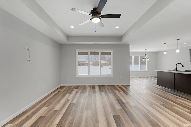 15384 Brimwillow Dr, Huntertown, IN 46748 - unfurnished living room featuring light wood-type flooring, ceiling fan, a sink, baseboards, and recessed lighting