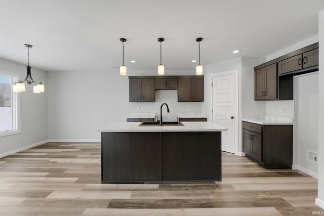15384 Brimwillow Dr, Huntertown, IN 46748 - kitchen featuring a sink, dark brown cabinets, baseboards, light wood-style floors, and recessed lighting