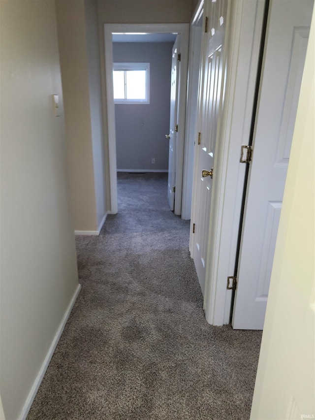 corridor with dark colored carpet