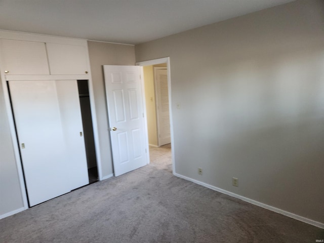 unfurnished bedroom featuring carpet and a closet