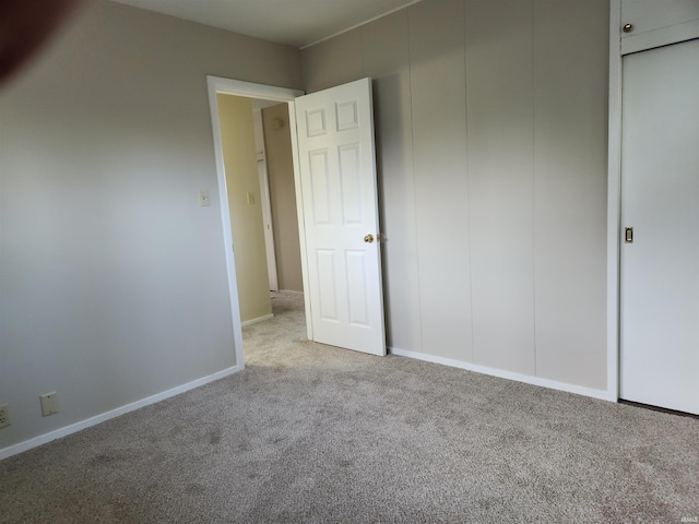 unfurnished bedroom with light colored carpet