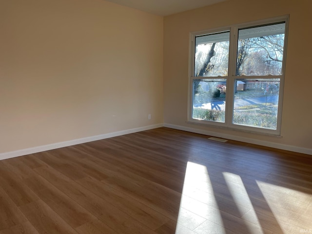 empty room with hardwood / wood-style floors