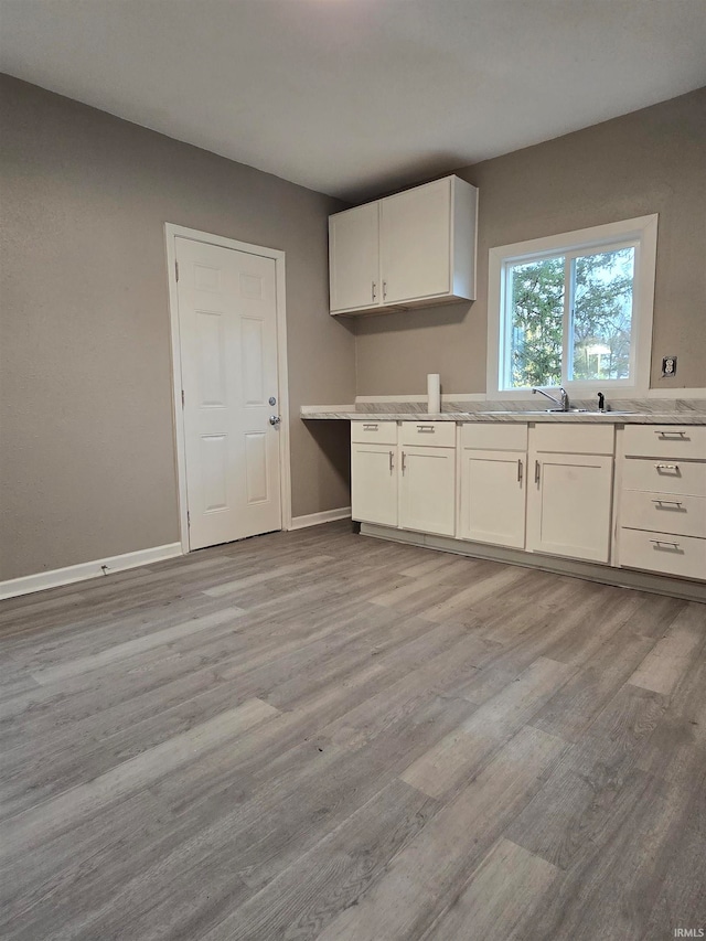 kitchen featuring white cabinets and light hardwood / wood-style floors