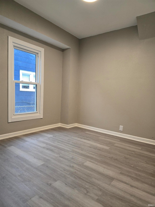 unfurnished room with wood-type flooring