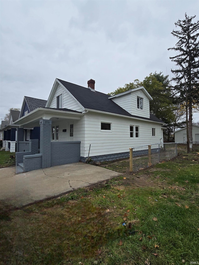 view of side of property with a lawn and a patio area