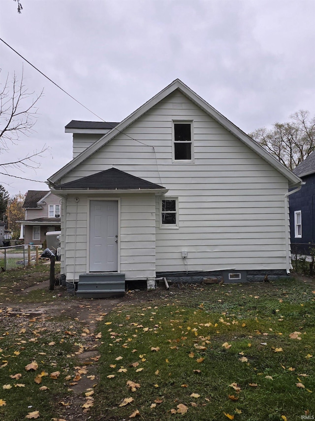 rear view of house with a lawn