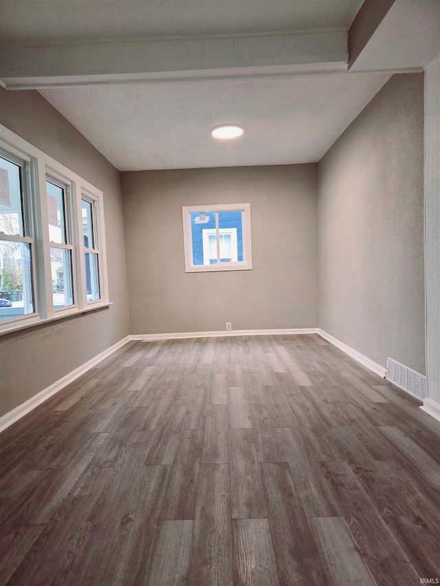 spare room featuring dark wood-type flooring