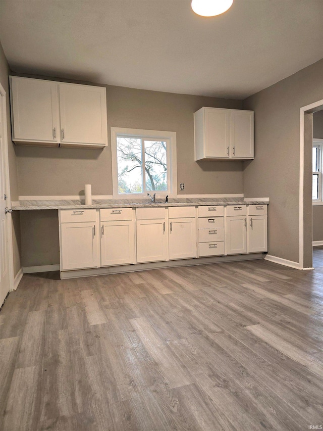 kitchen featuring white cabinets and hardwood / wood-style flooring