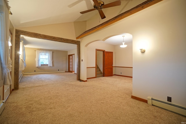 empty room with baseboard heating, ceiling fan, carpet flooring, and vaulted ceiling