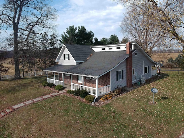 farmhouse with a porch and a front yard