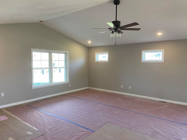 spare room featuring plenty of natural light, ceiling fan, and lofted ceiling