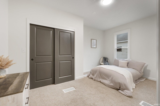 carpeted bedroom with a closet