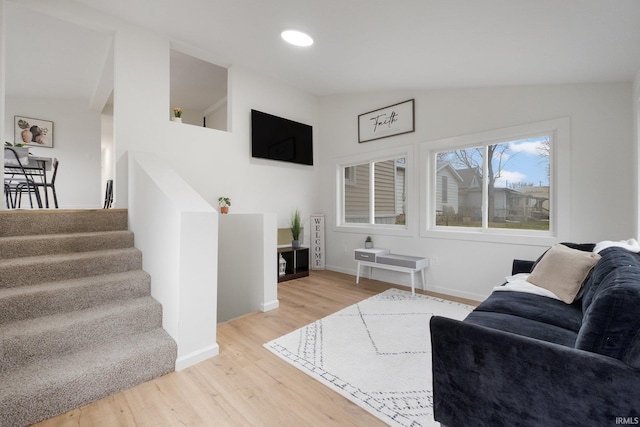 living room featuring hardwood / wood-style floors and lofted ceiling