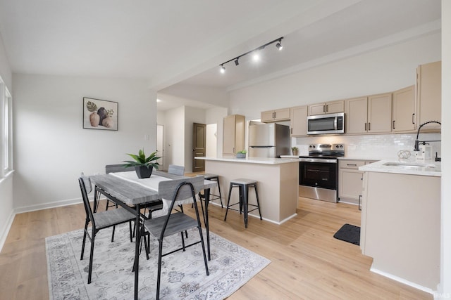 dining area featuring light hardwood / wood-style floors and sink