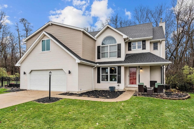 view of property with a front yard and a garage