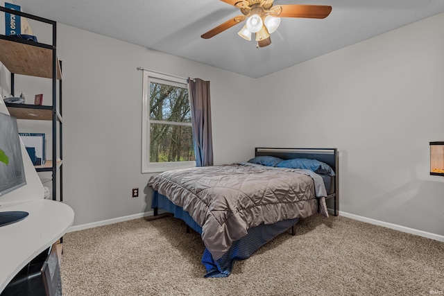 carpeted bedroom featuring ceiling fan and baseboards