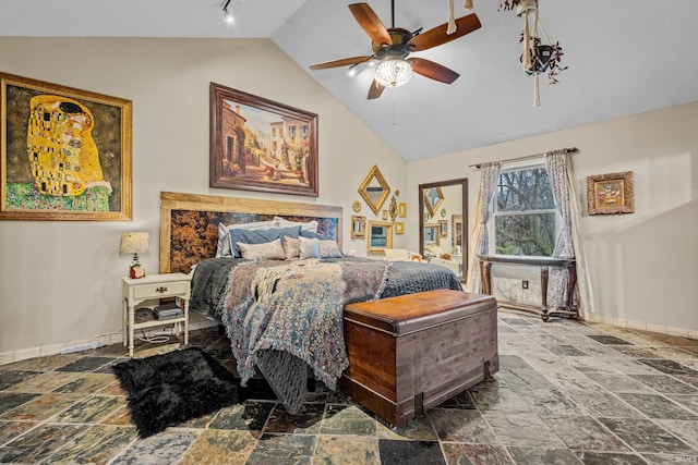 bedroom with lofted ceiling, stone tile flooring, a ceiling fan, baseboards, and rail lighting