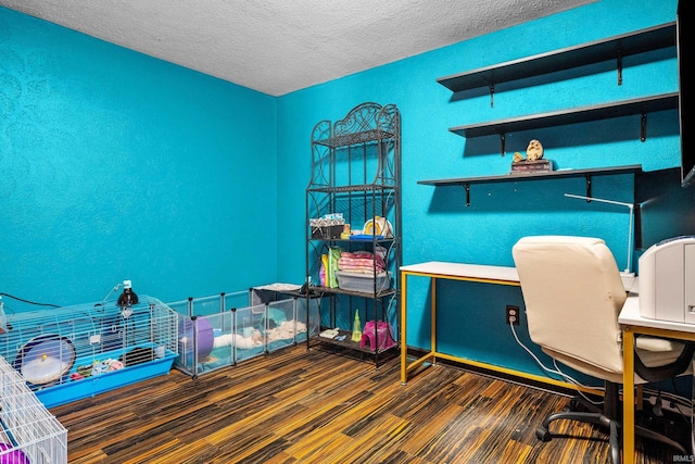 office featuring a textured wall, dark wood finished floors, and a textured ceiling