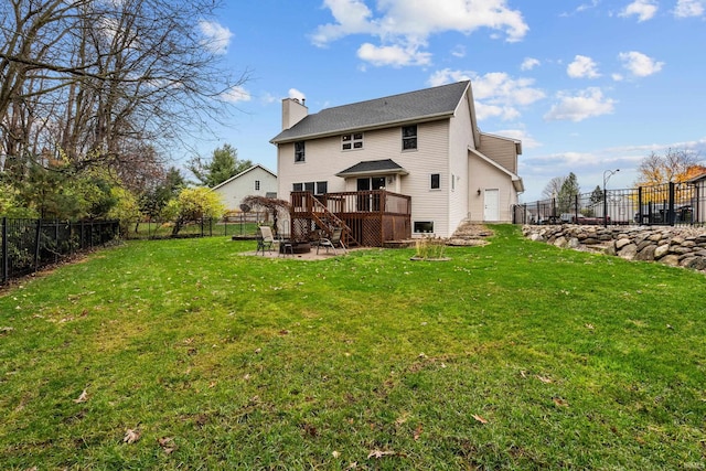 rear view of property featuring a chimney, a lawn, stairway, a fenced backyard, and a wooden deck